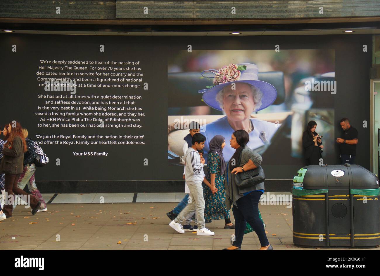 Pedestrians walk past a billboard on Oxford street in memory of Queen ...