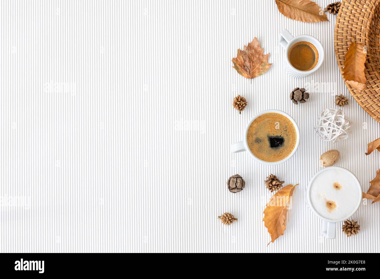 Autumn composition with cups of coffee and leaves on a white background ...