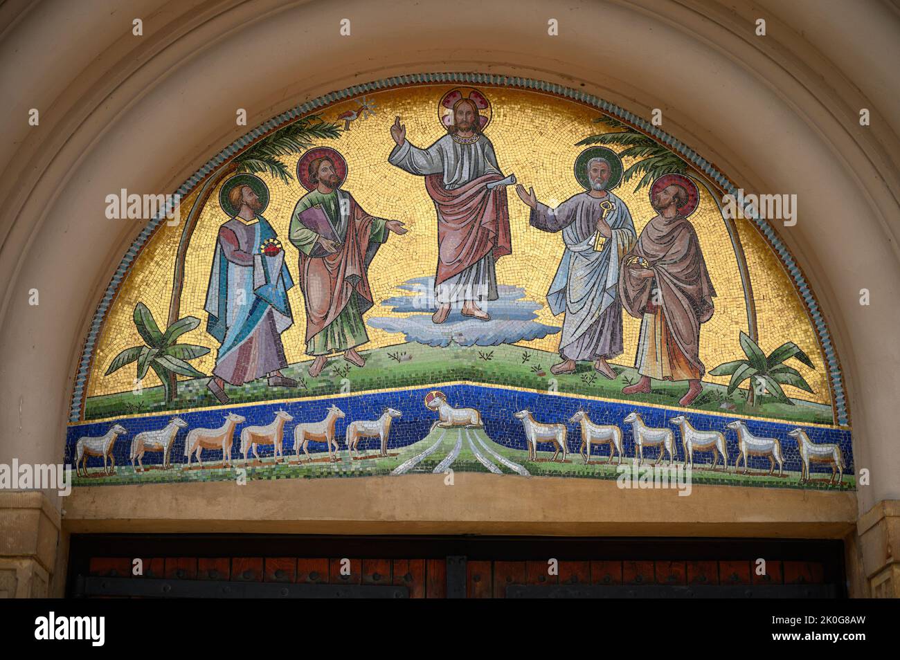 The portal of the Church of Saints Cosmas & Damian in Clervaux, Luxembourg depicting Jesus Christ, Saints Peter, Paul, Cosmas and Damian. Stock Photo