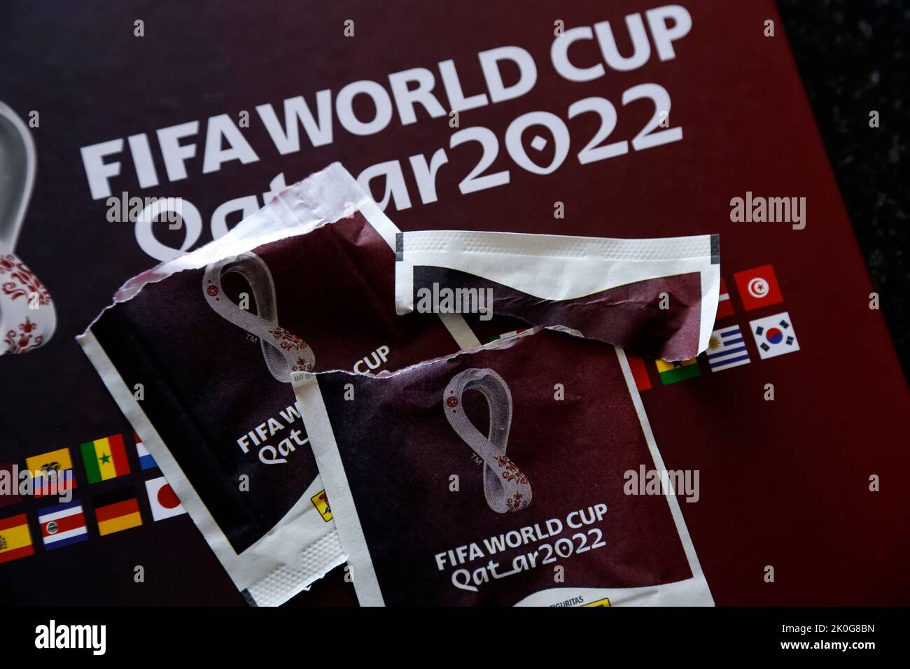 Minas Gerais, Brazil - September 07, 2022: Selective focus of open stickers pack and Panini 2022 FIFA World Cup Qatar Official licensed sticker album Stock Photo