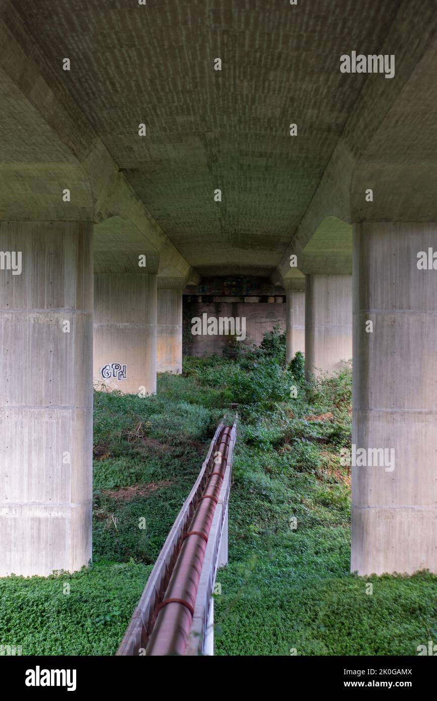 Pipes under concrete highway bridges Stock Photo Alamy