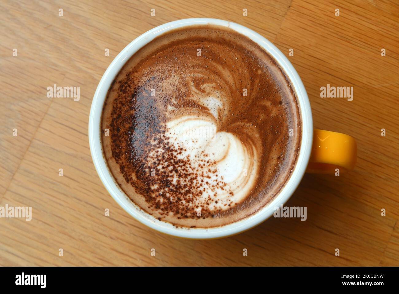 cup of hot cappuccino coffee on wooden table Stock Photo