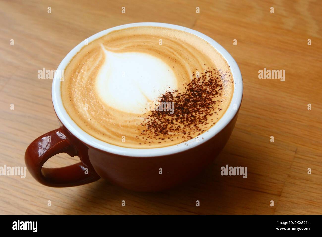 cup of hot cappuccino coffee on wooden table Stock Photo