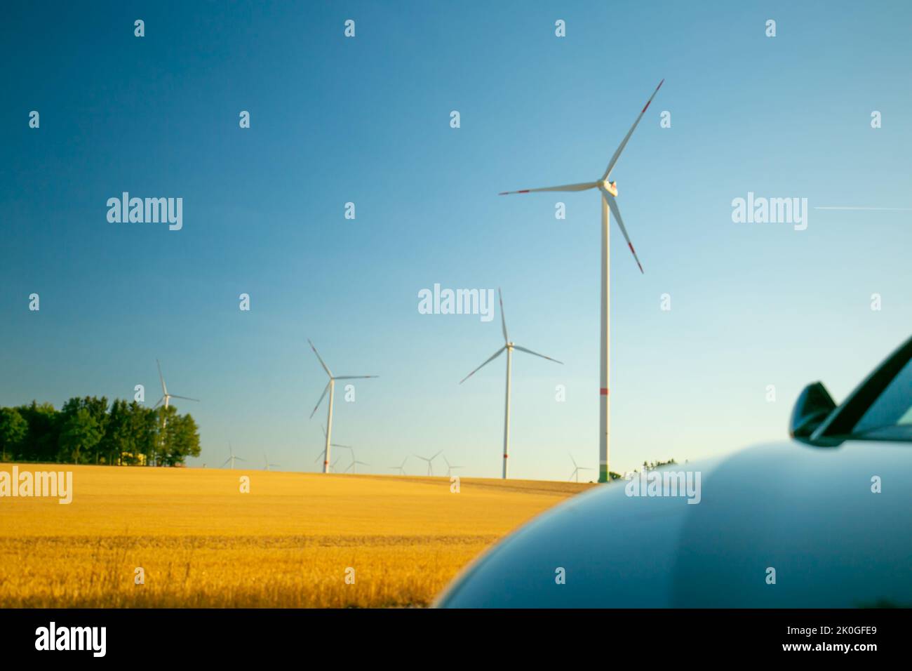 Wind generators and electric car in the field .Alternative energy for