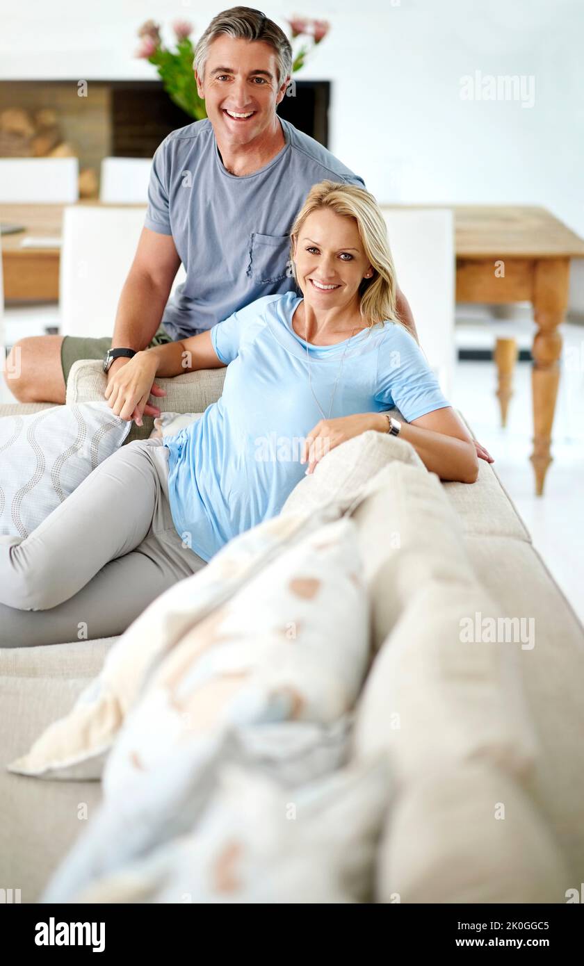 We live a contented life. Cropped portrait of a loving mature couple relaxing on the sofa at home. Stock Photo