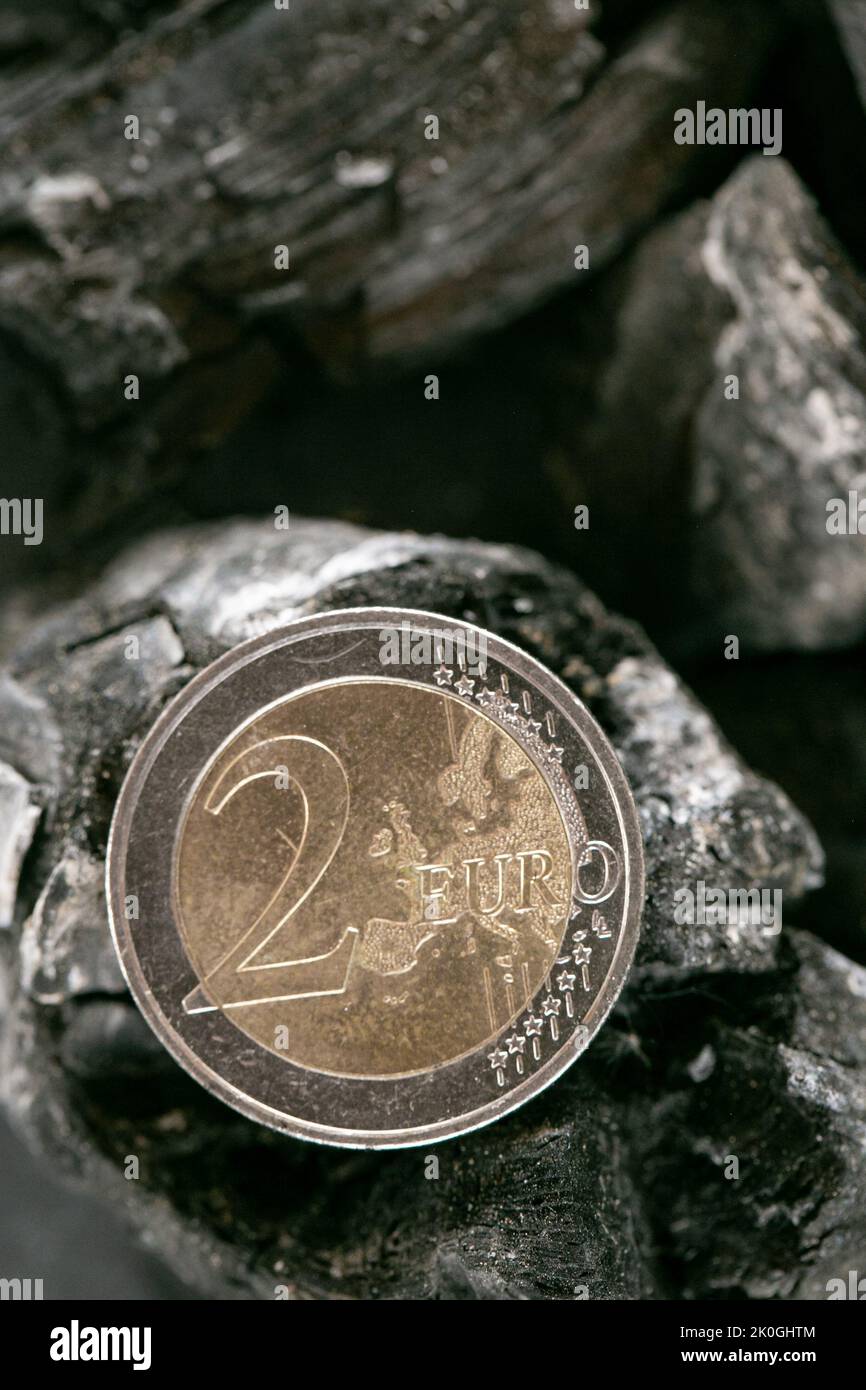 Coal cost. euro coin on a piece of coal.Heating with coal.Purchase of