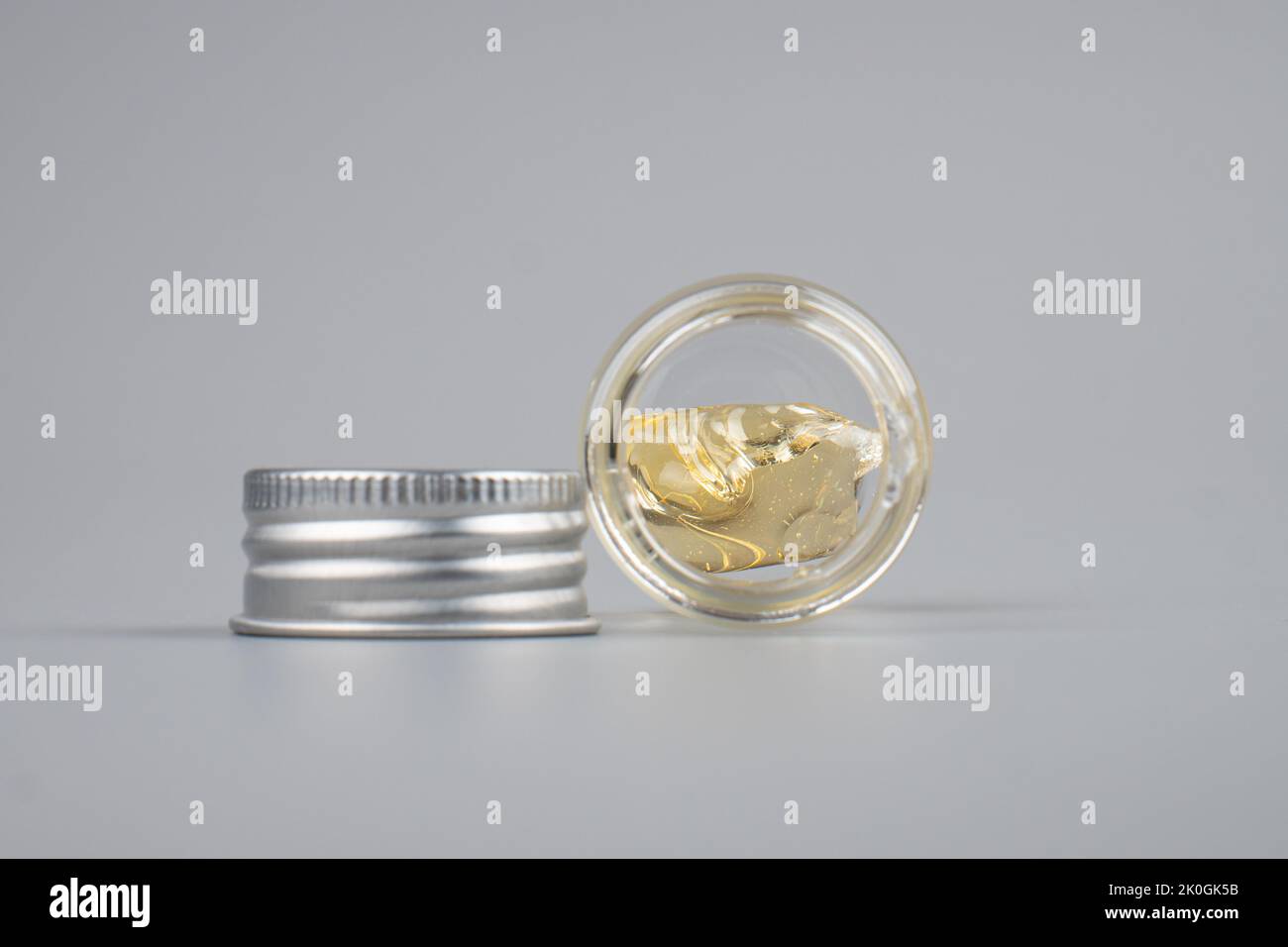 piace cannabis extract wax with transparent bottle closeup on gray background. Stock Photo