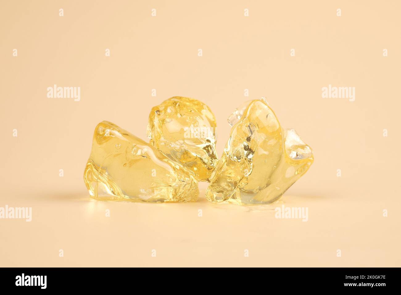pieces golden shattered resin cannabis, yellow clean marijuana wax. Stock Photo