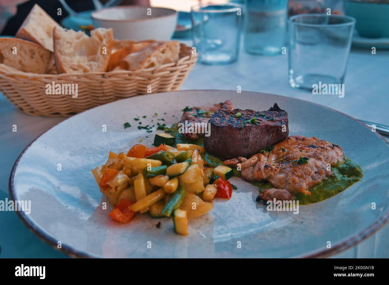 Various meat and vegetables on the table in restaurant Stock Photo