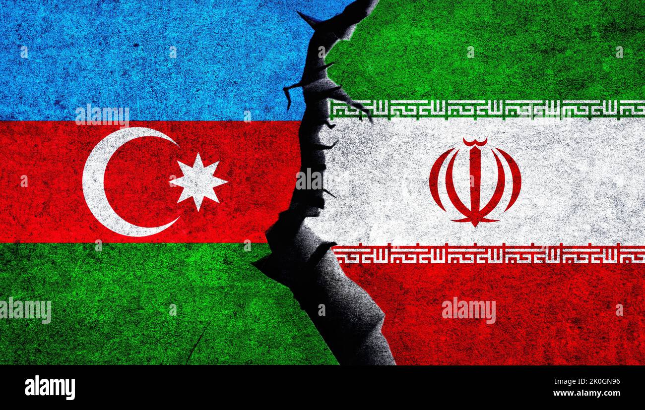 Iran and Azerbaijan flags together on a wall with cracked. Azerbaijan Iran conflict Stock Photo