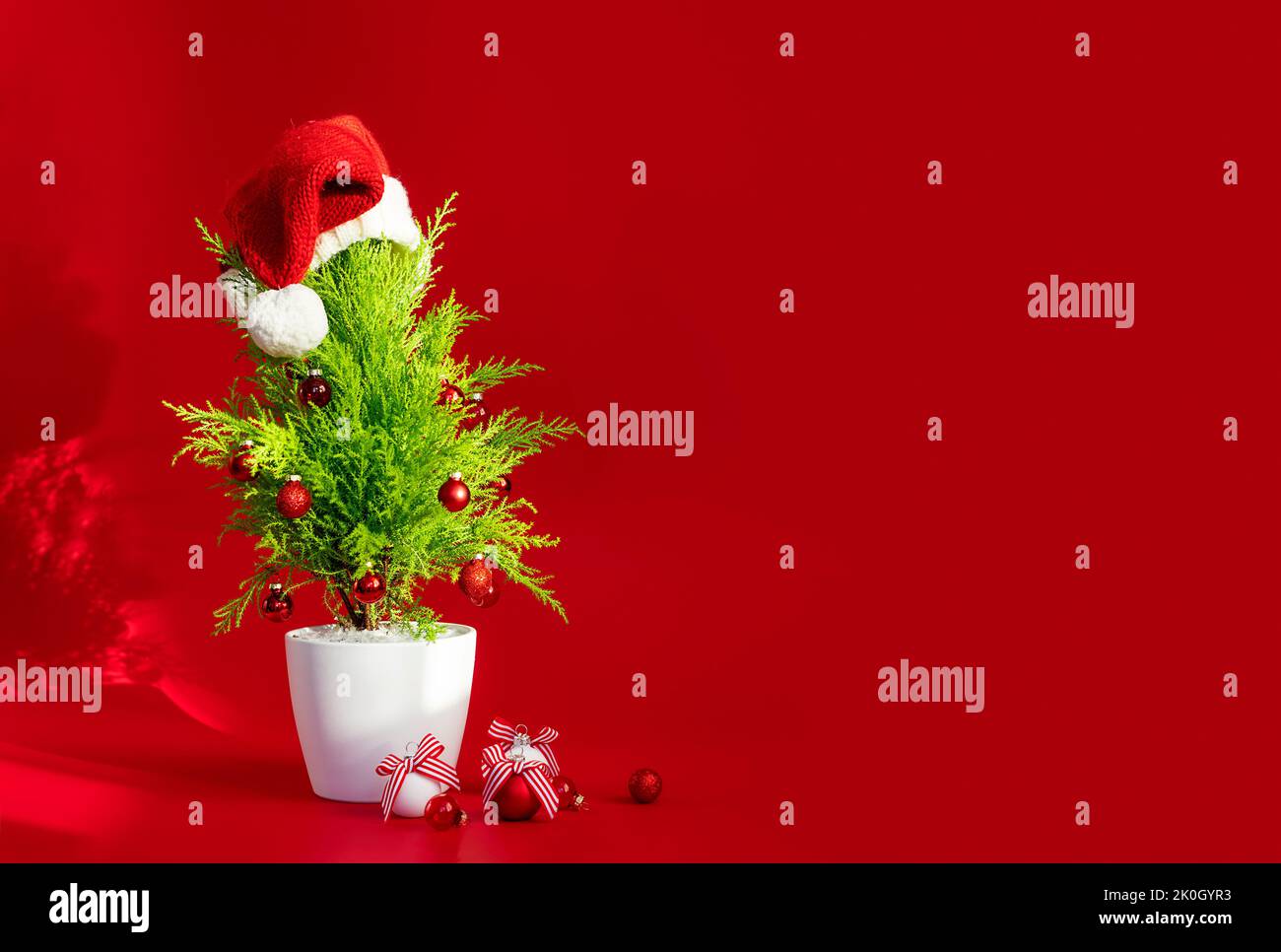 Christmas tree and decorations on a red background with copy paste ...