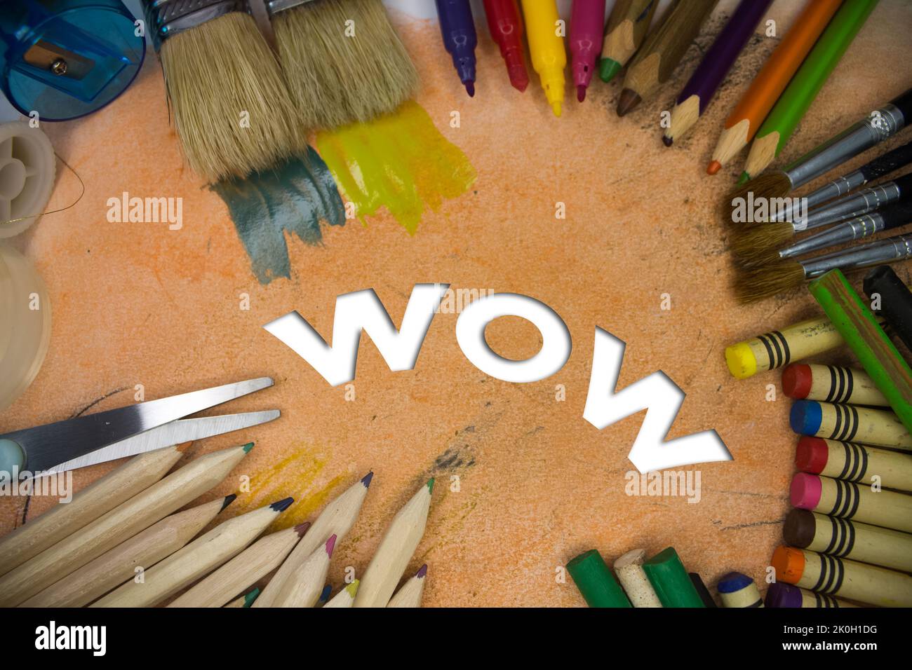 Overhead shot of school supplies with Wow text. Brushes, pencils, artistic tools. Art And Craft Work Tools. Stock Photo