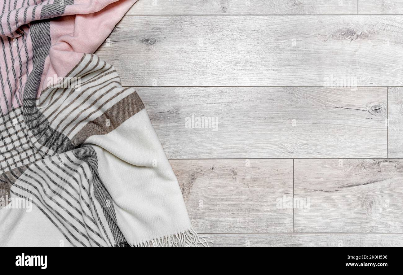 Warm blanket on the background of the laminate. Stock Photo