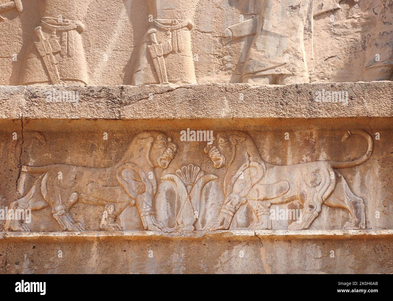 Bar-relief depicting two lions above the entrance to the tomb of Artaxerxes III, located on the slope of Rahmet Mount, Persepolis, Iran. UNESCO world Stock Photo