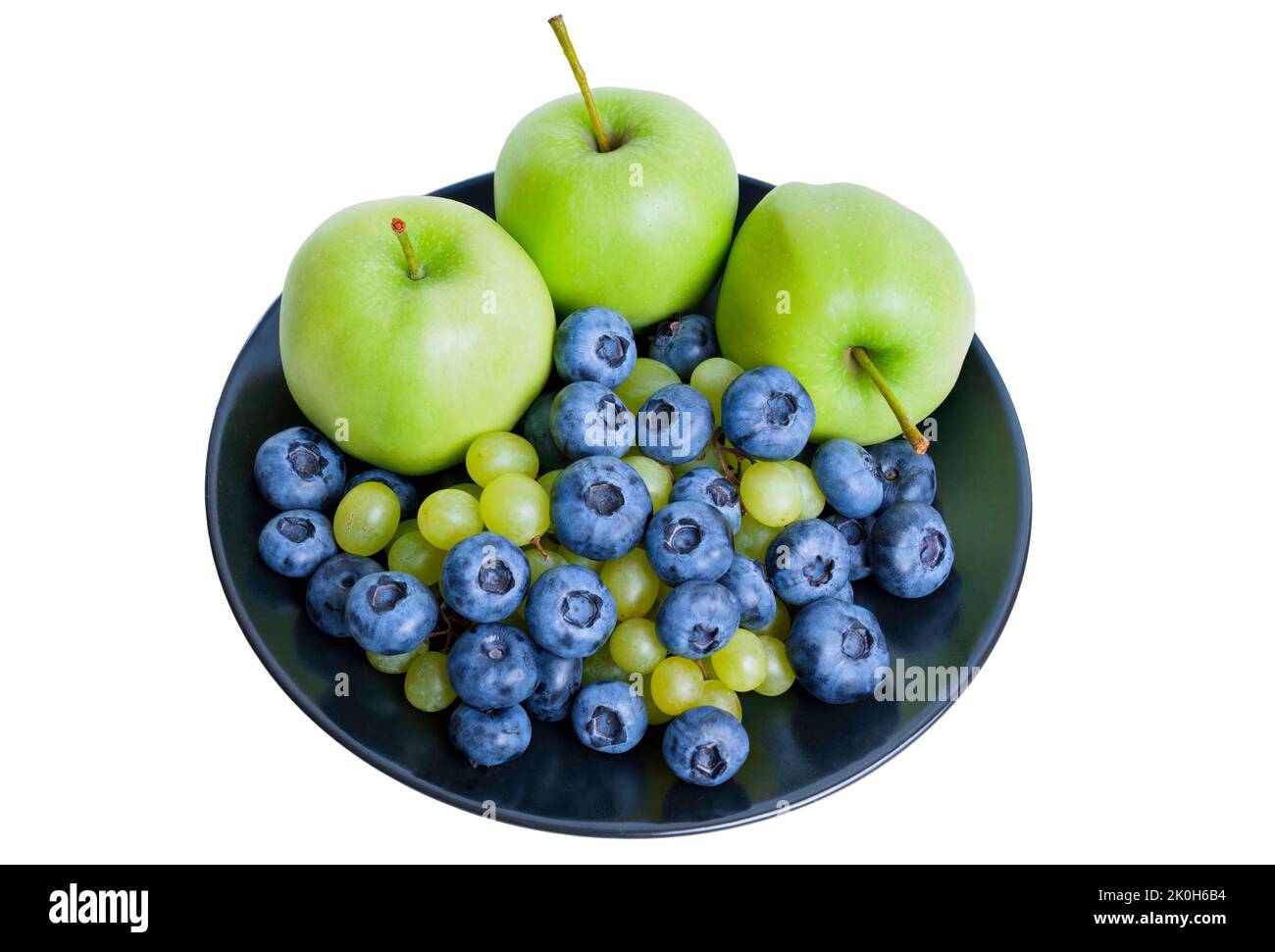 Green apples, blueberries and grapes on a black plate isolated on white Stock Photo