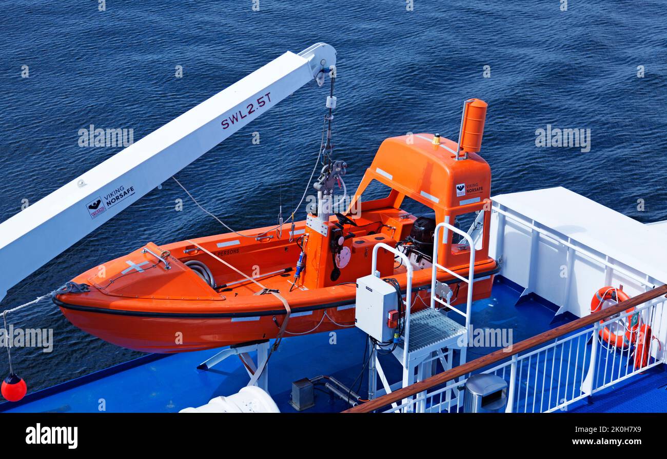 Vaasa, Finland - June 20, 2022: orange lifeboat on large ferry Stock Photo