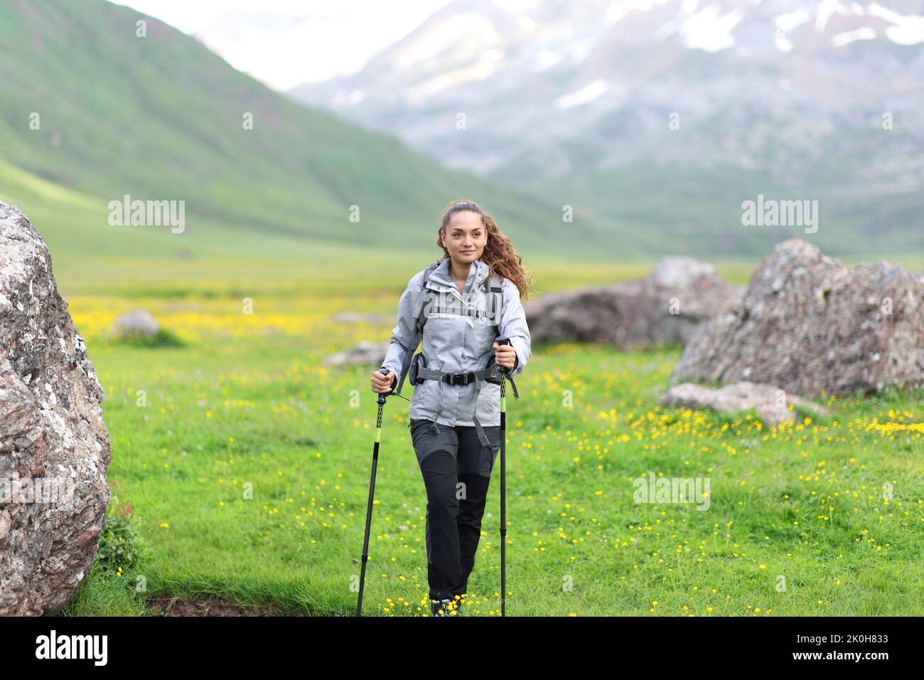 Front view portrait of a hiker walking towards you in a valley Stock Photo