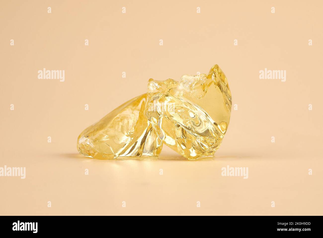 yellow wax piece with high THC, clear cannabis resin stone. Stock Photo