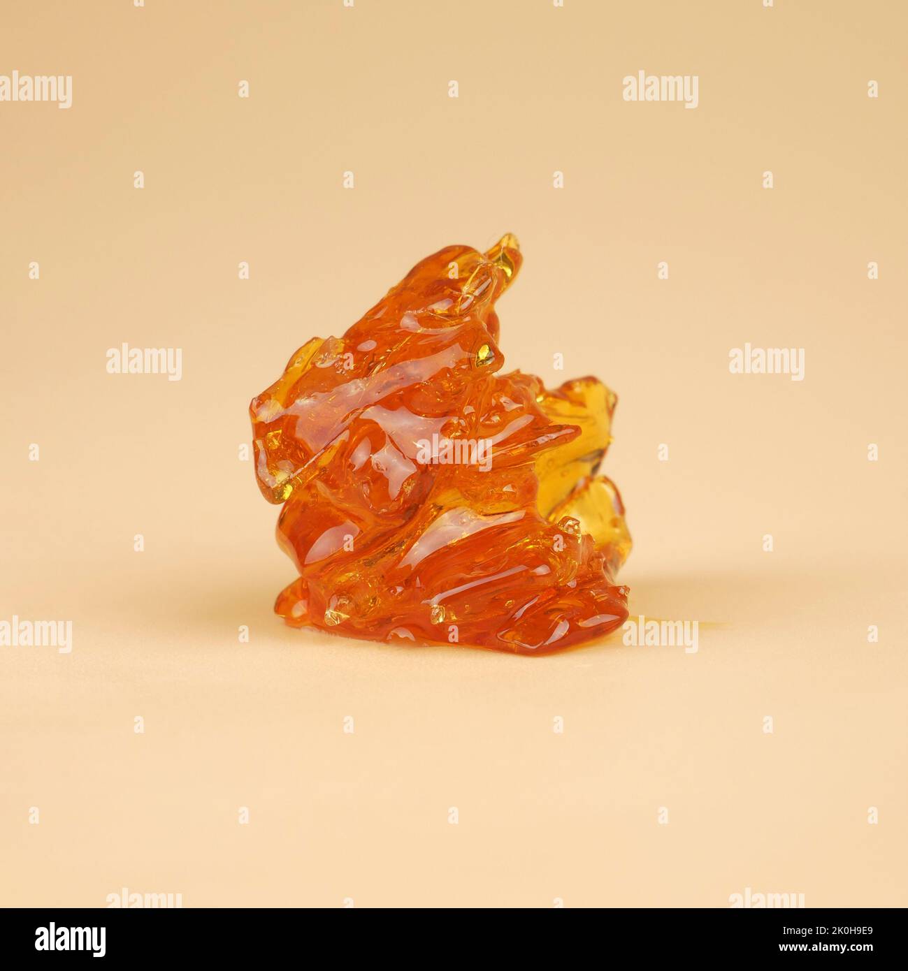 amber yellow piece of cannabis wax with high thc close up. Stock Photo