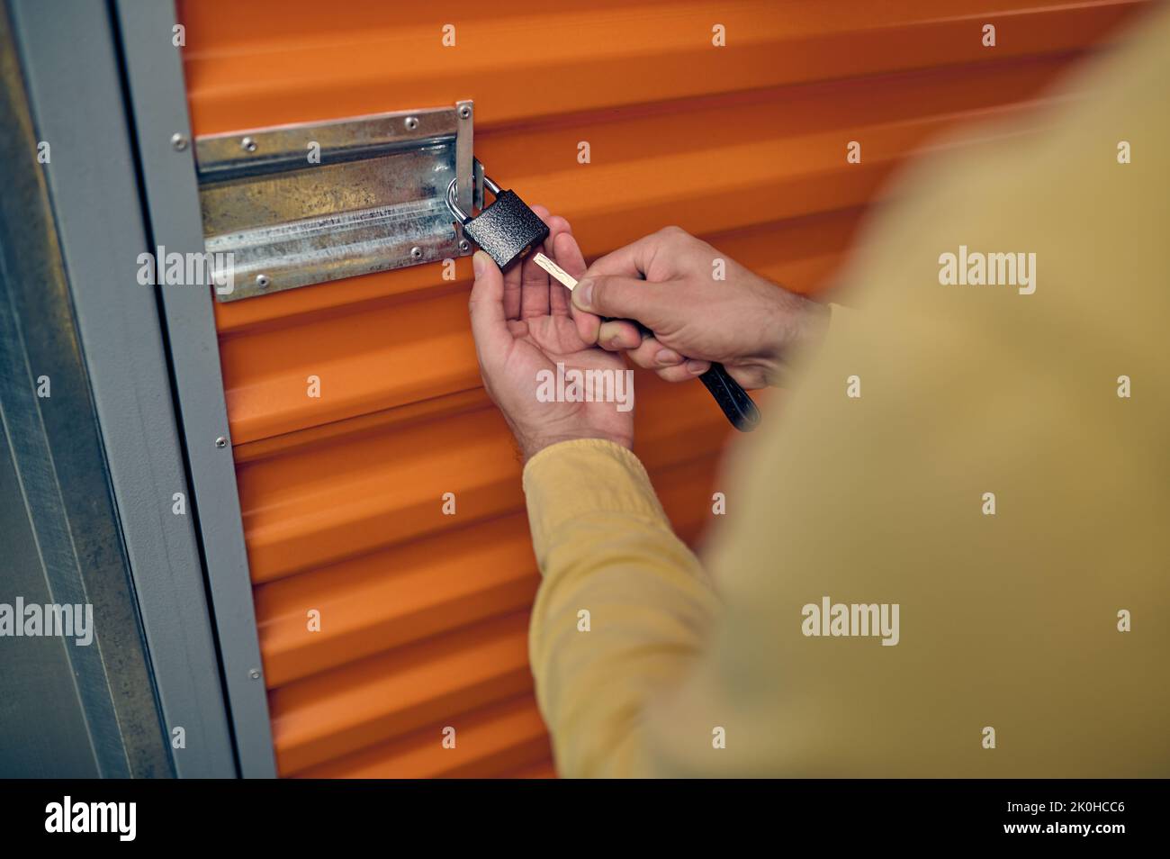 Male employee locking the storage unit door Stock Photo Alamy