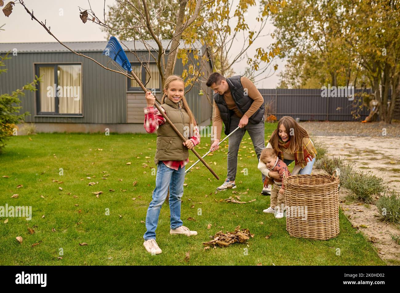 Whole family cleaning their yard in autumn Stock Photo Alamy