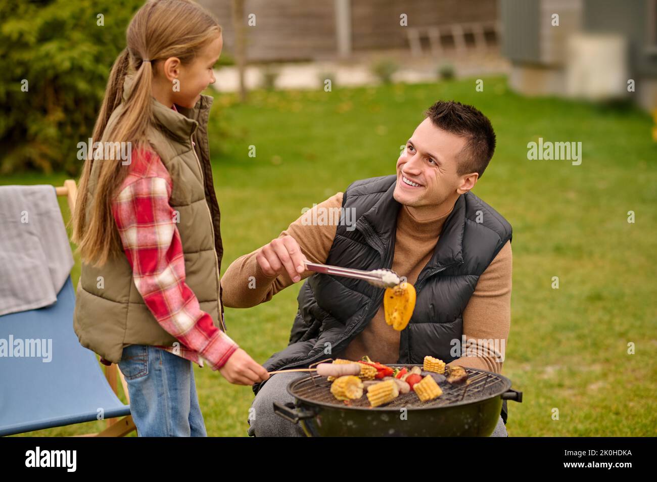 Daughter and dad having a picnic in the backyard Stock Photo