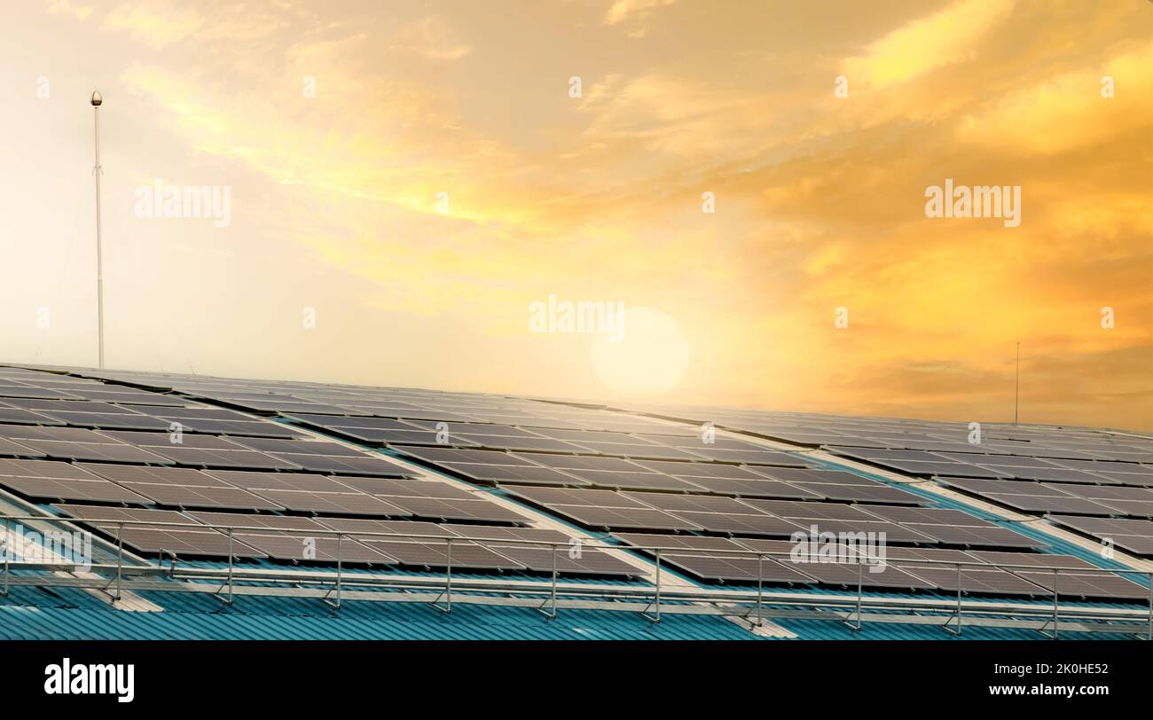 Solar energy for factory or warehouse building. Solar panels on the roof of industrial plant. Commercial solar. Industrial photovoltaic panels. Roof Stock Photo