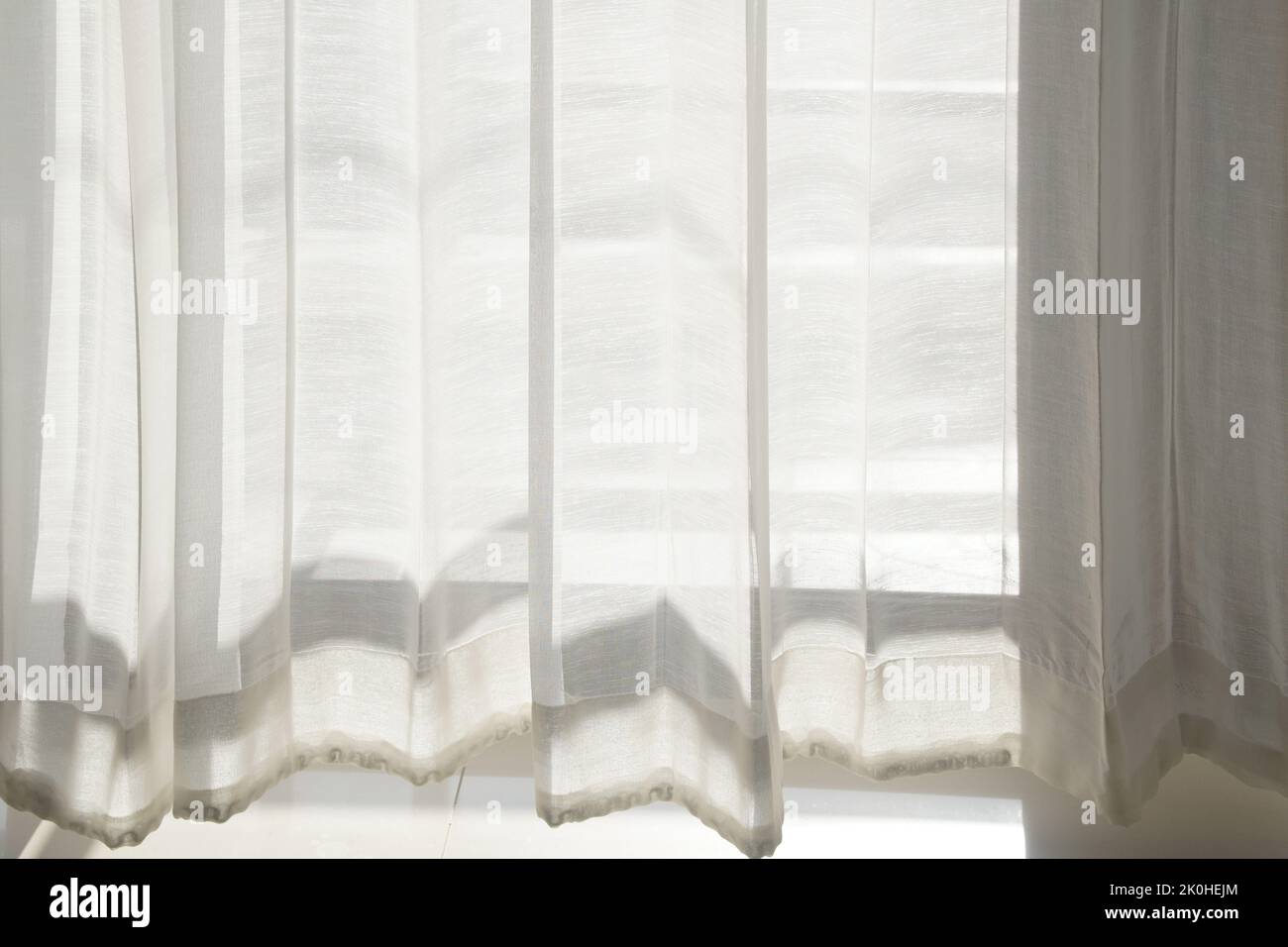 white transparent fabric see through sheer window curtain at home. Stock Photo