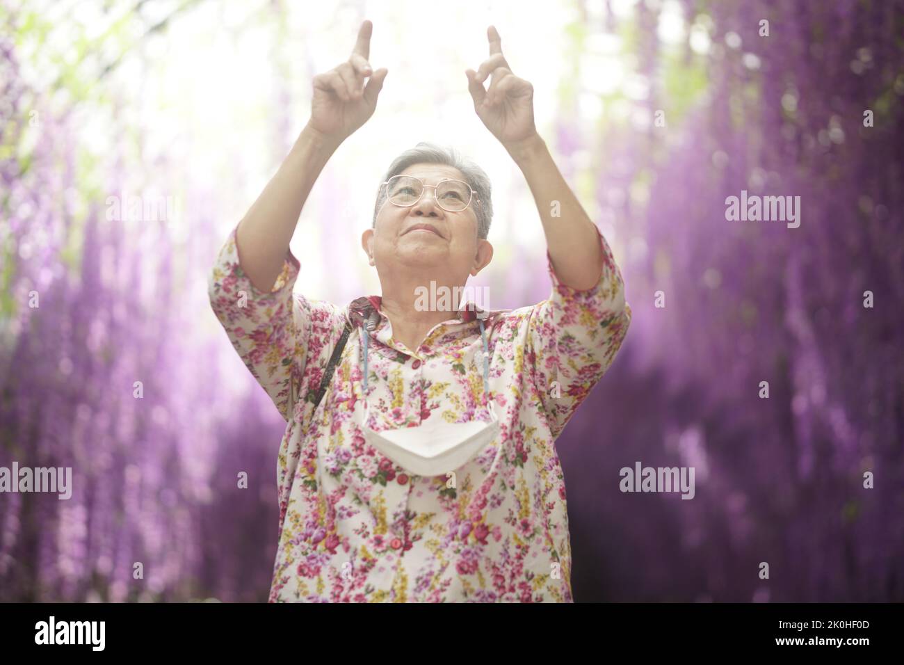 old elderly elder senior woman resting relaxing walking in garden Stock Photo