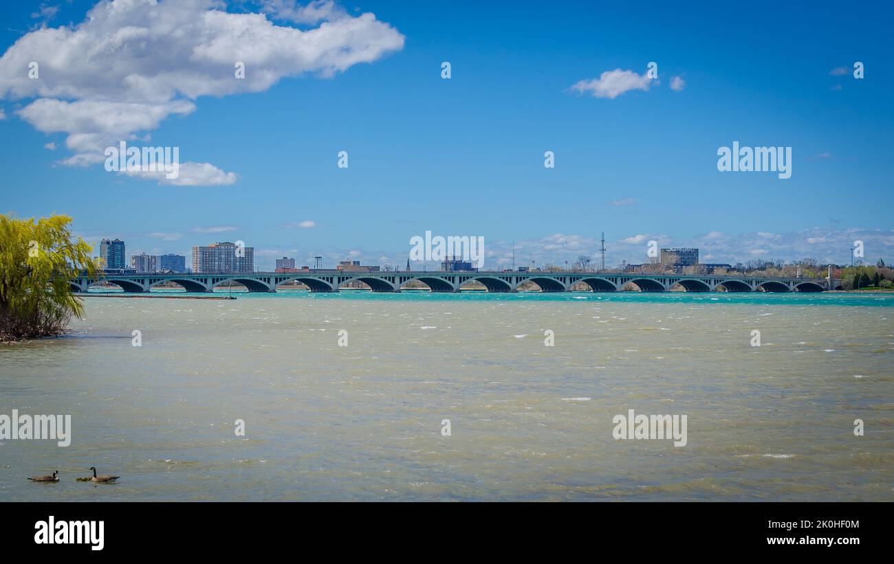 A scenic shot of the MacArthur Bridge across the Detroit River in Detroit, Michigan Stock Photo