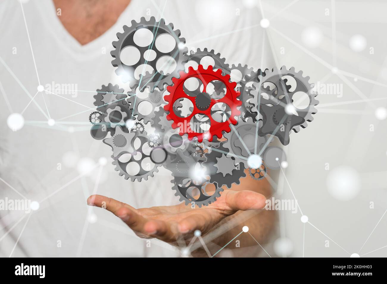 A businessman presenting a 3D rendered gear system in cyberspace Stock