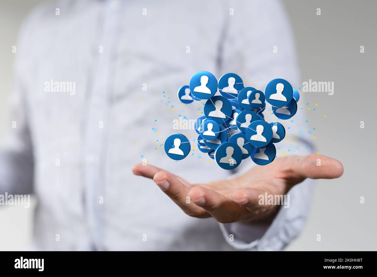 A businessman showing 3D rendered user icons floating on the palm of ...