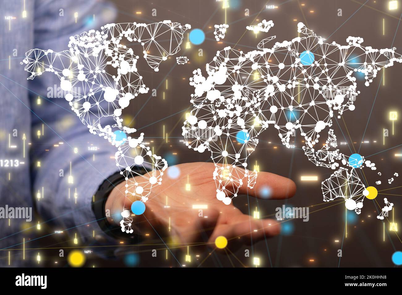 The world map with dots hovering above the person's hand. Stock Photo