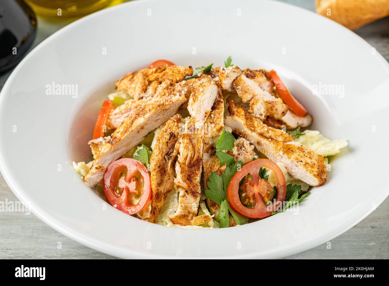 Fresh Mediterranean salad with grilled chicken breast. top view Stock Photo