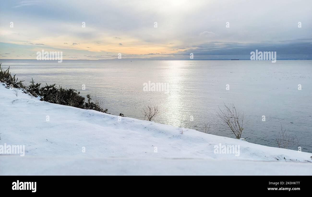 A landscape with snowy shore under blue cloudy sky with sunlight Stock ...