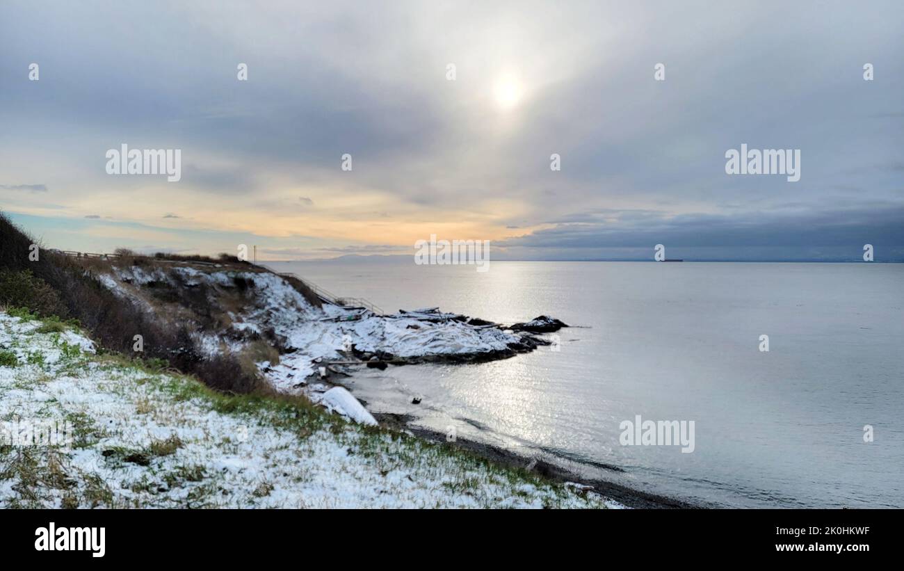 A landscape with snowy shore under blue cloudy sky with sunlight Stock ...