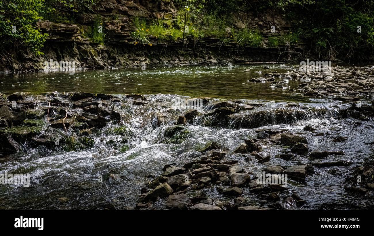 A rocky river flowing in a scenic display Stock Photo - Alamy