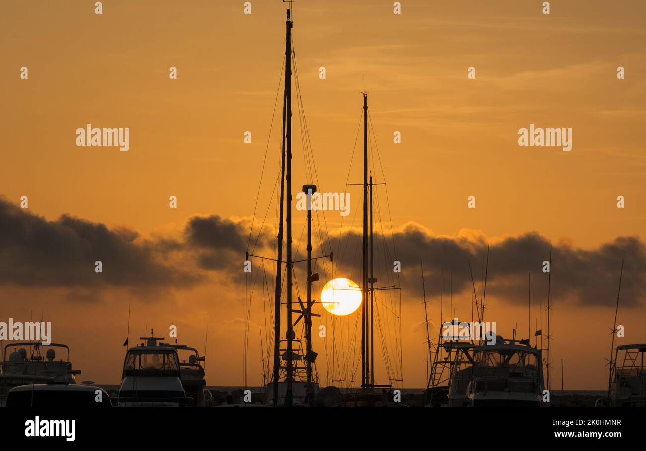 A scenic view of the sunset over boats and coast, silhouette shot Stock ...