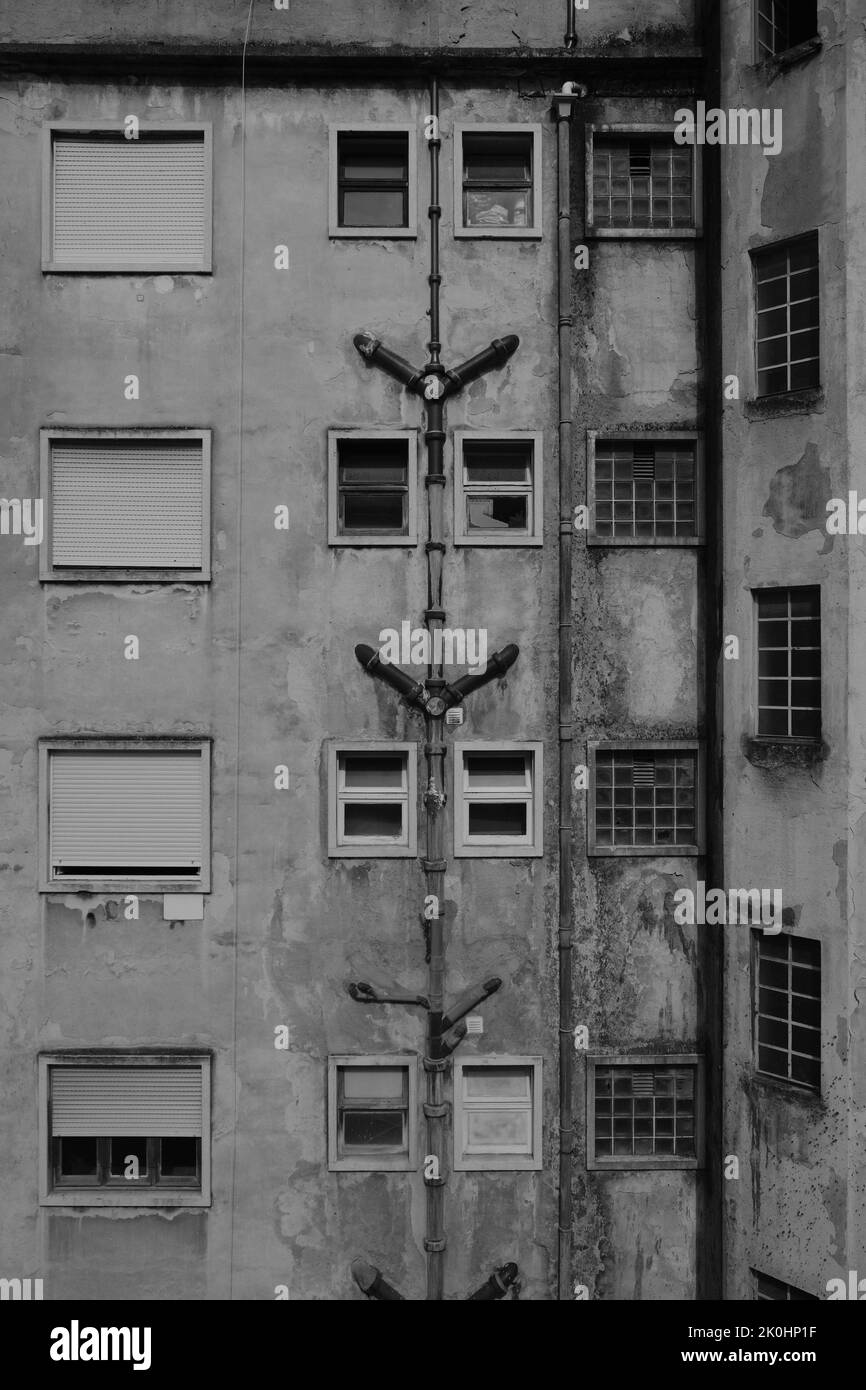 A vertical grayscale shot of an old apartment building Stock Photo