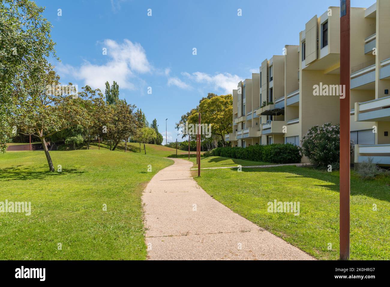 A walkway in garden of Troia near apartment complexes, Grandola municipality, Portugal Stock Photo
