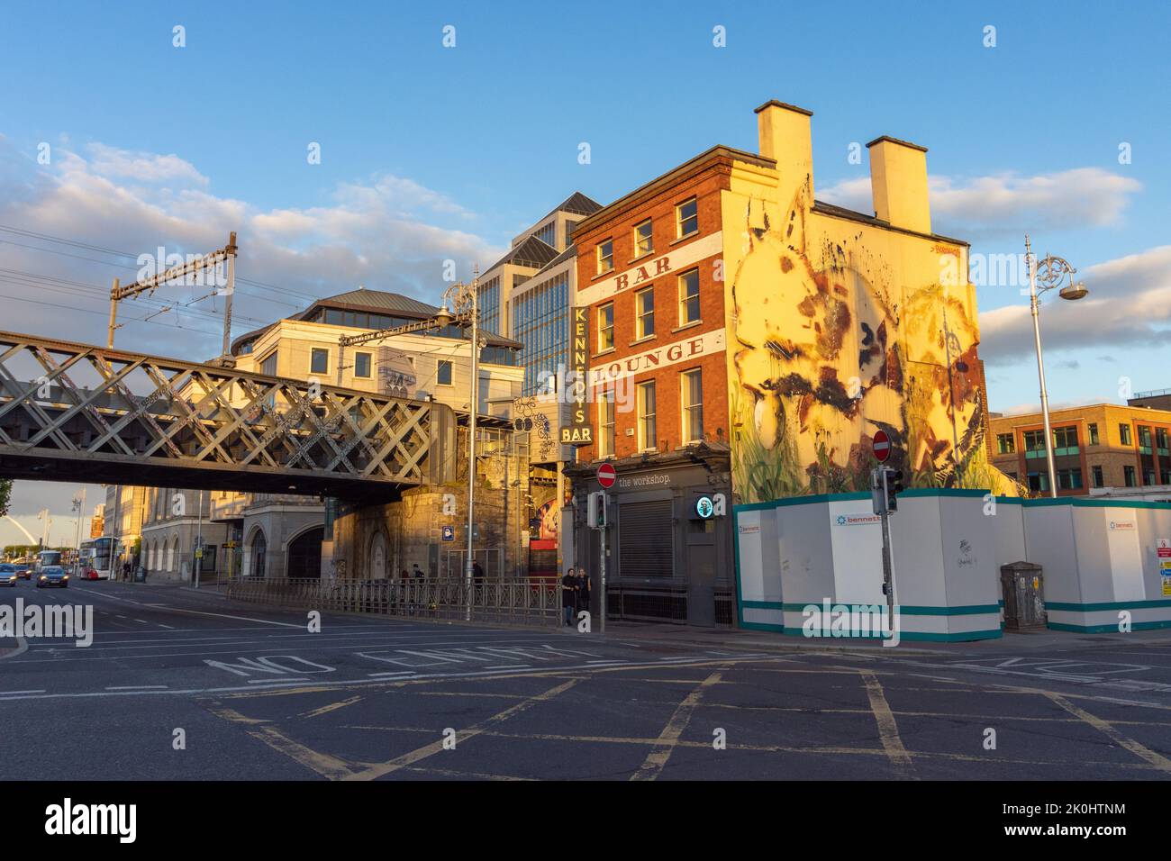 The Workshop Gastropub building in Dublin, Ireland under sunlight with graffiti, an overpass and traffic Stock Photo