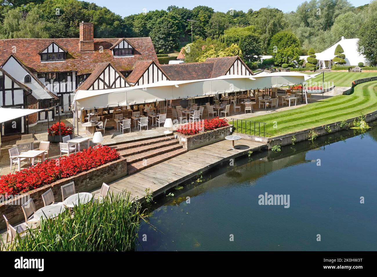 Idyllic Constable Country riverside landscape at Milsom Group Talbooth restaurant & wedding venue manicured lawns Essex side of River Stour England UK Stock Photo