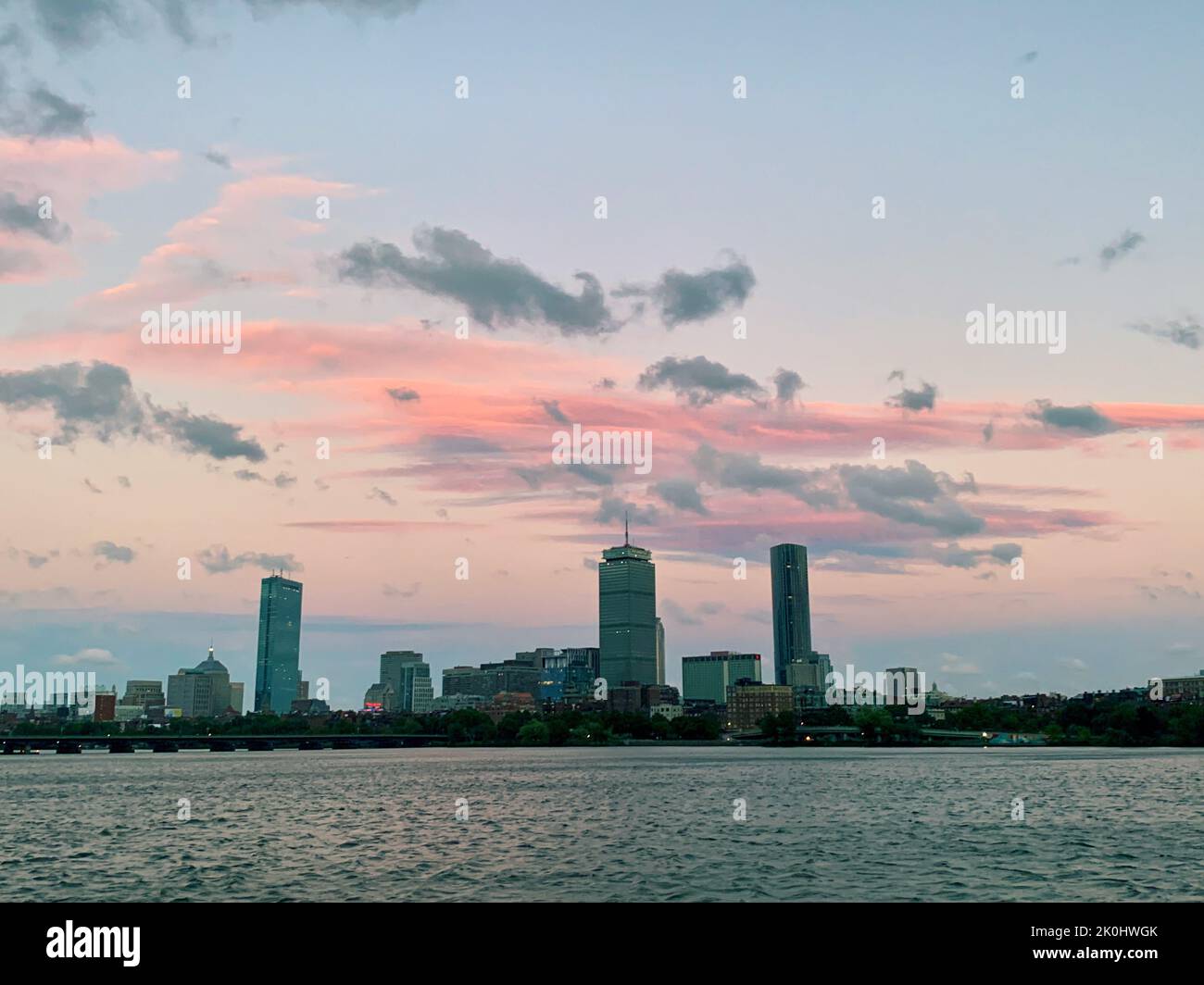A river in front of modern city skyline at sunset Stock Photo - Alamy
