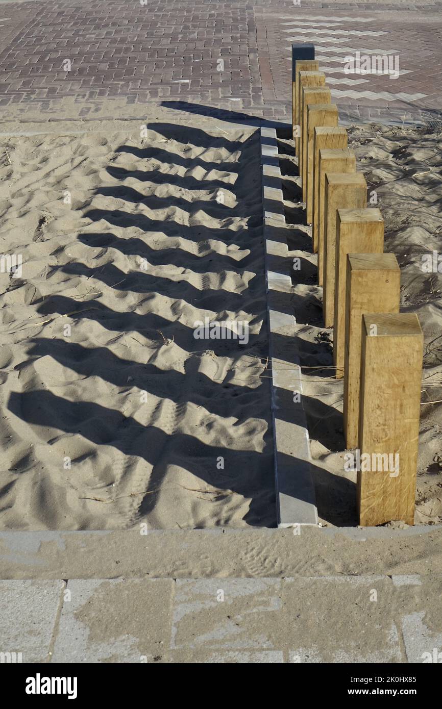 A vertical shot of a wooden fence and its shadow on sand Stock Photo ...
