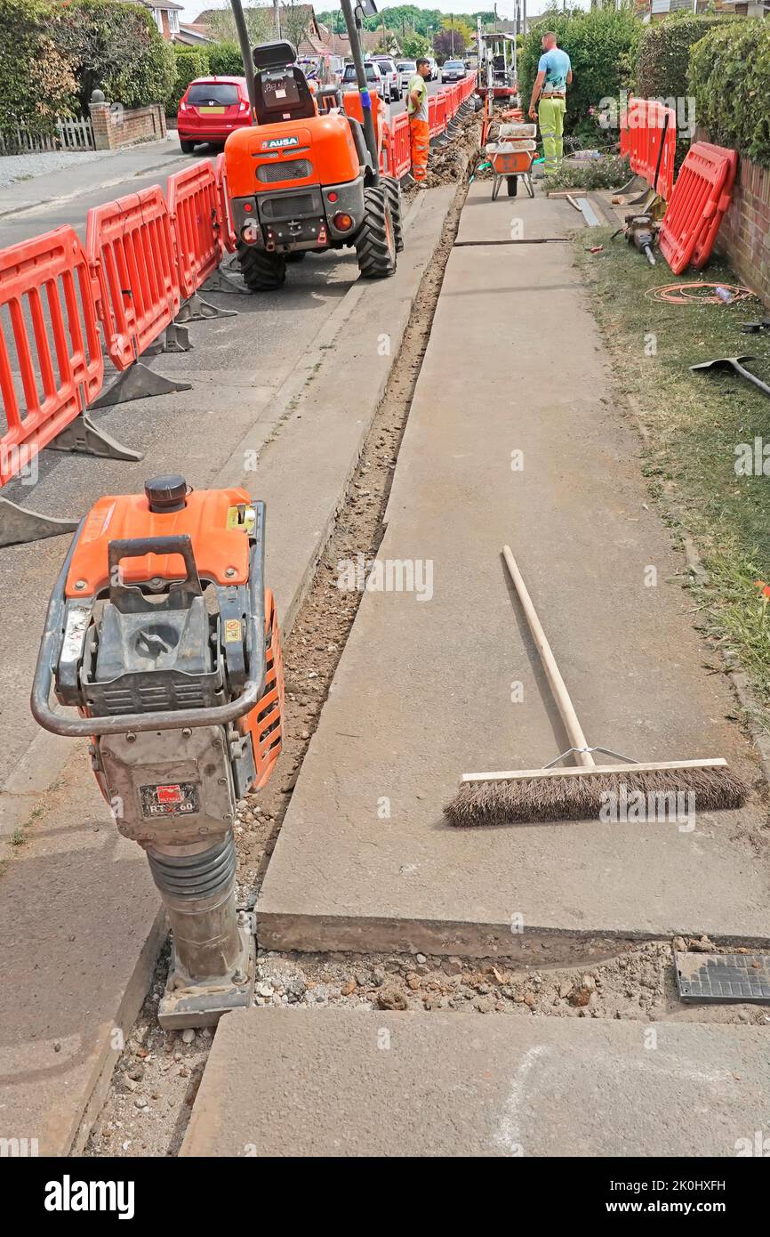 Diesel engine whacker vibrating compactor tool & pavement fast fibre optic broadband cable trench backfill with short spur to house connection box* UK Stock Photo