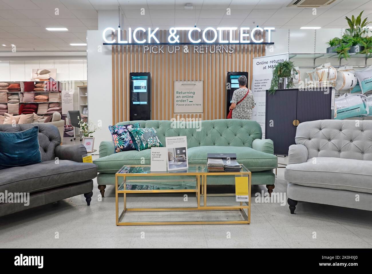 M&S customer Click & Collect pick up & returns facility with furniture display in large Marks and Spencer retail shopping business store in England UK Stock Photo