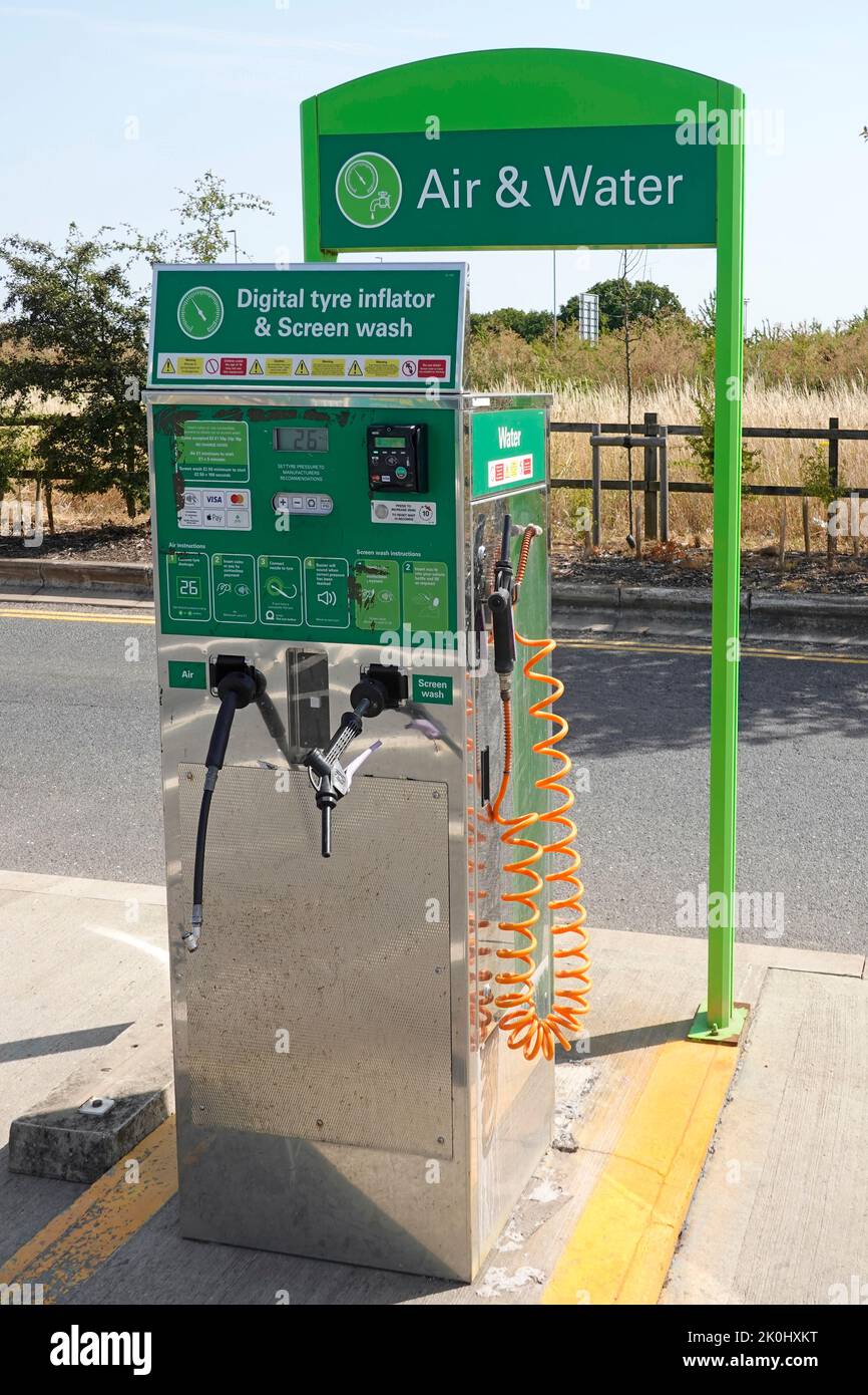 Digital tyre inflator screen wash at automated pre payment Air & Water facility in outdoor parking bay at BP petrol fuel station A 12 Essex England UK Stock Photo