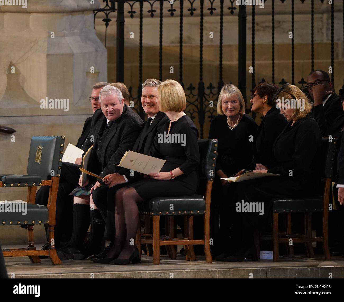 (front row, left to right) SNP Westminster leader Ian Blackford, Labour leader Keir Starmer and Prime Minister Liz Truss, sit in front of Harriet Harman (left) and Leader of the House of Commons Penny Mordaunt (right) ahead of the arrival of King Charles III and the Queen Consort at Westminster Hall, London, where both Houses of Parliament are meeting to express their condolences following the death of Queen Elizabeth II. Picture date: Monday September 12, 2022. Stock Photo