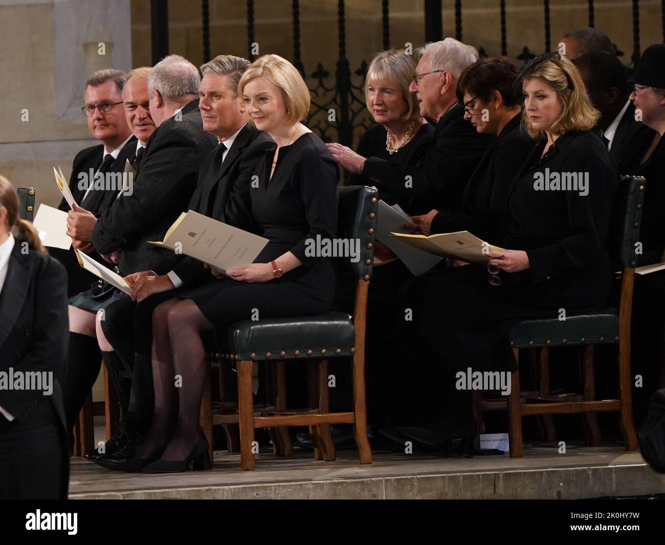(front row, left to right) Liberal Democrat Leader Sir Ed Davey, SNP Westminster leader Ian Blackford, Labour leader Keir Starmer and Prime Minister Liz Truss, sit in front of Harriet Harman (second row, left) and Leader of the House of Commons Penny Mordaunt (second row, right) ahead of the arrival of King Charles III and the Queen Consort at Westminster Hall, London, where both Houses of Parliament are meeting to express their condolences following the death of Queen Elizabeth II. Picture date: Monday September 12, 2022. Stock Photo