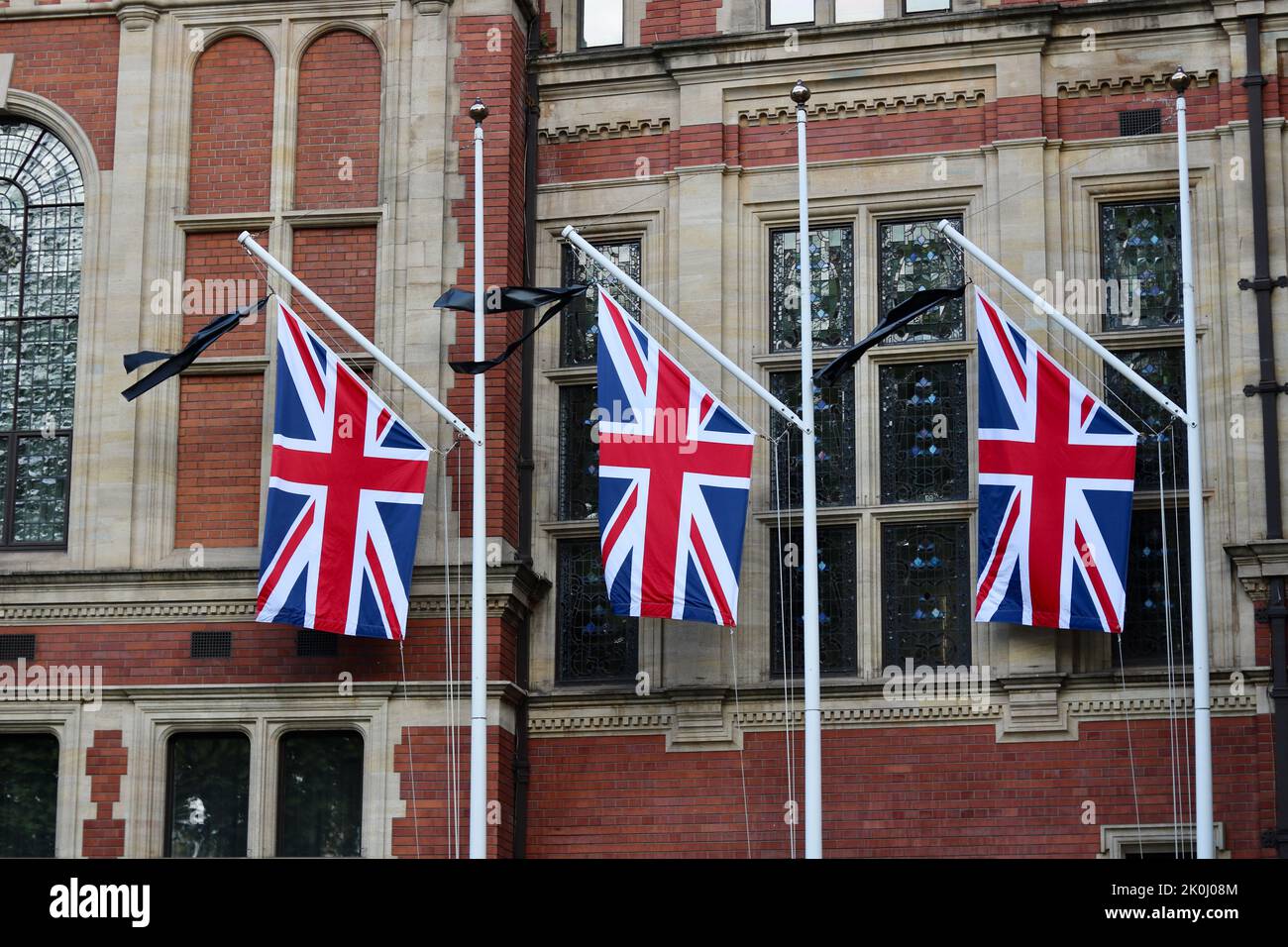 11 September 2022 - London, UK: Union Jacks with black mourning ribbons to side Stock Photo
